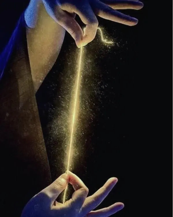 Two hands holding a glowing golden thread