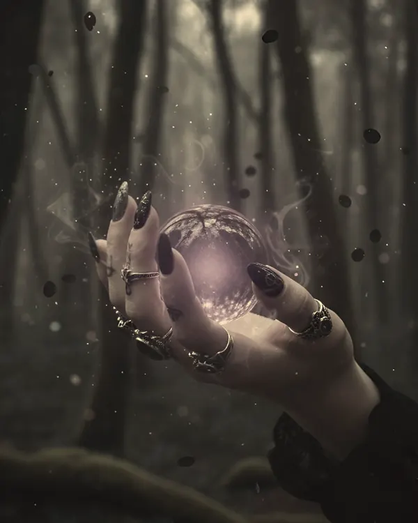 A hand with a glowing orb in a misty forest